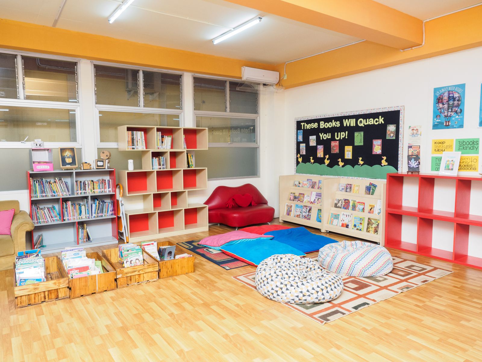 A reading corner with cushions and bookshelves