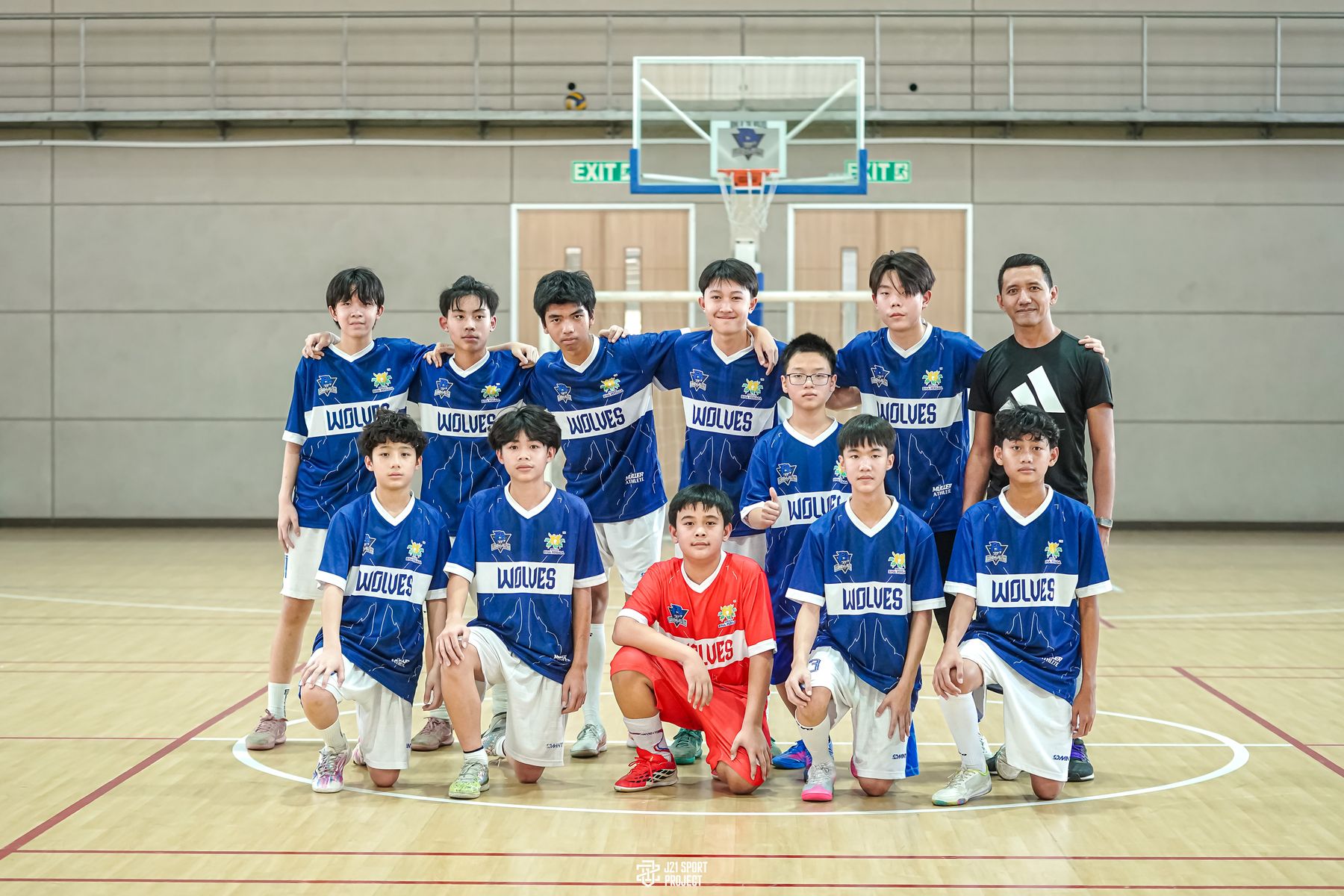 The SBP Wolves futsal team with their coach in the sports hall