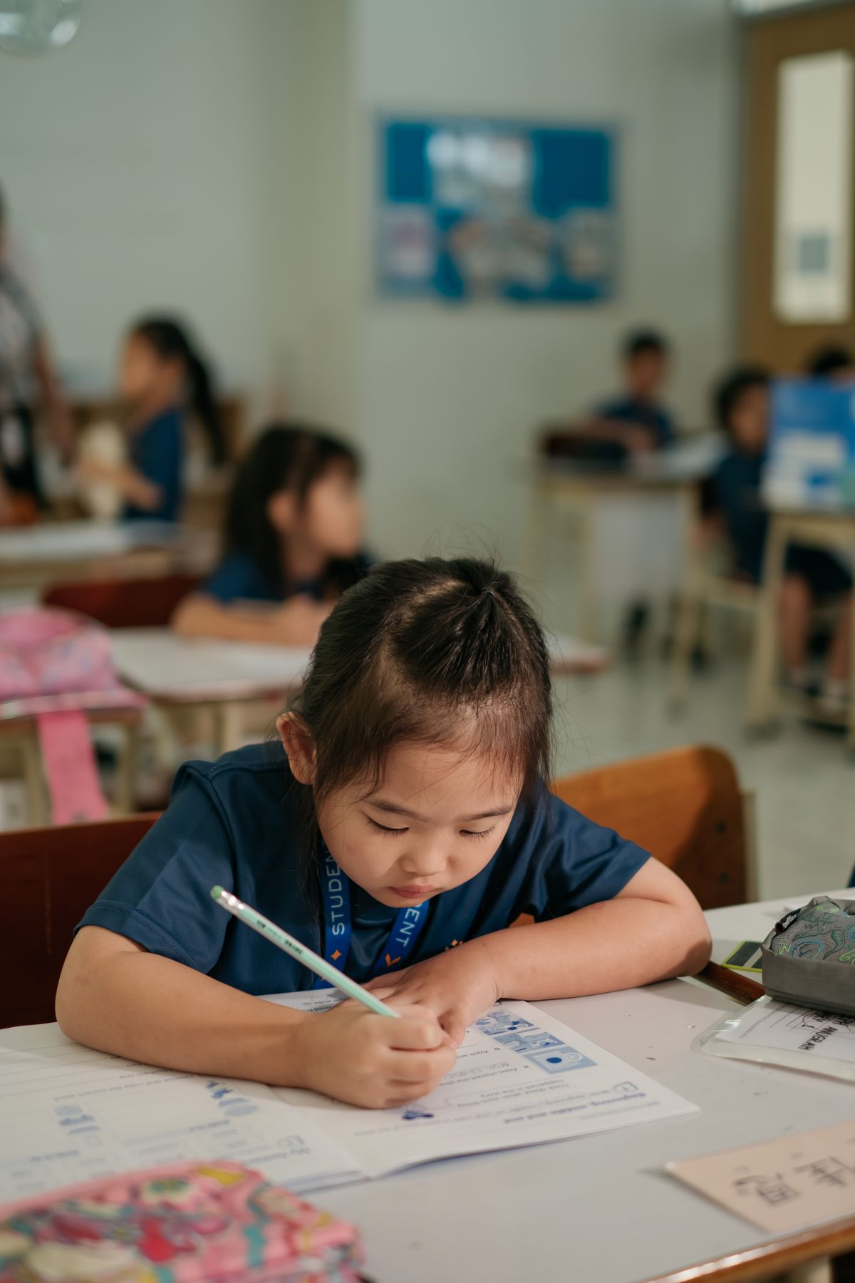 A Primary student writing in her exercise book